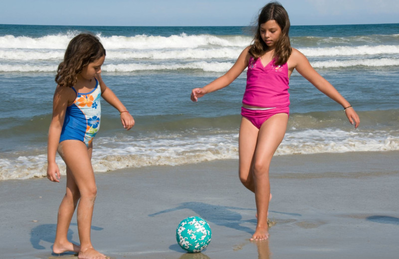 Kids kicking ball on beach at The Sea Ranch Resort.