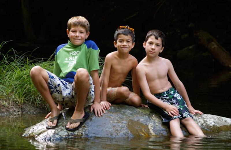 Kids cool off in the creek at Common Grounds Center.