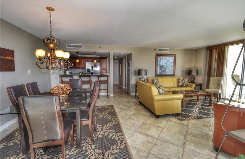 Rental kitchen and living room at Barefoot Resort Rentals.