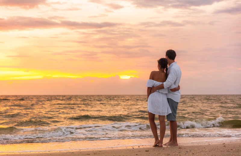 Couple on beach at ValGal Vacation Rentals.