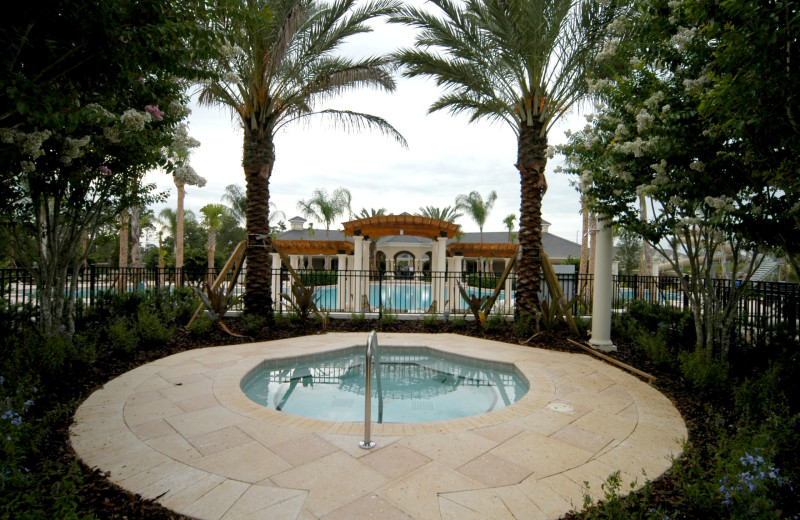 Outdoor community pool and spa at Elite Vacation Homes.