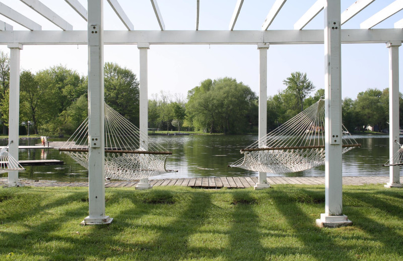 Scenic view of pergola with hammocks overlooking Lake Couchiching.