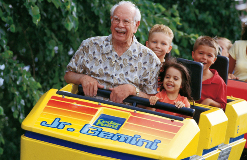 Family riding roller coaster at Cedar Point Resort.