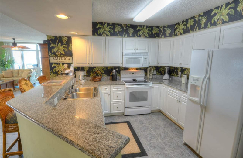 Rental kitchen at CondoLux Vacation Rentals.