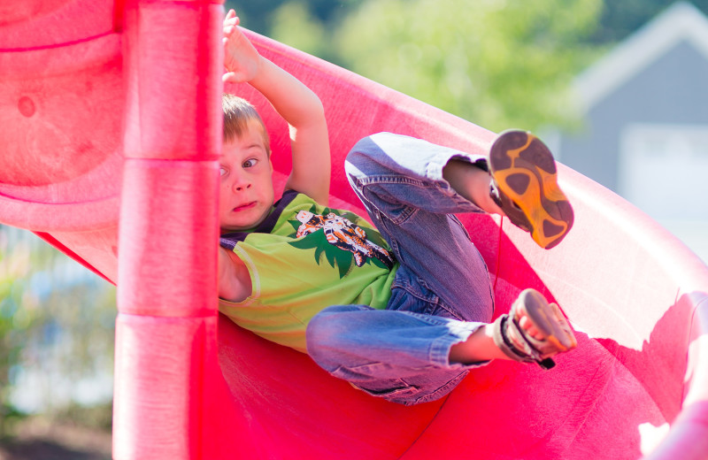 Kid sliding at Sandbanks Summer Village Cottage Resort.