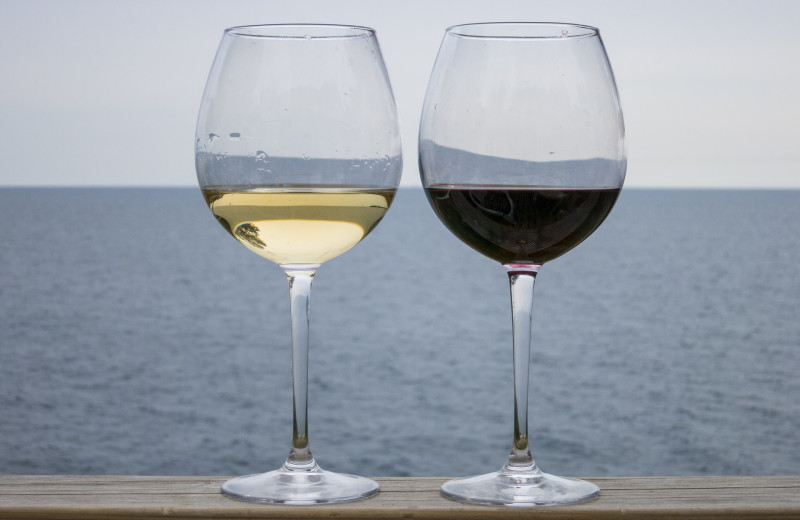 Wine glasses and lake view at Waters Edge B&B Resort.