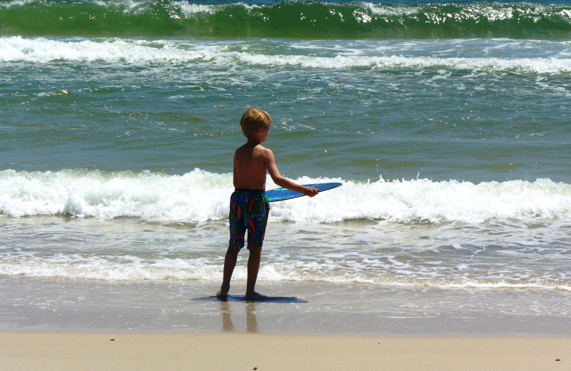 Kid on beach at Gulf Shores Vacation Rentals.