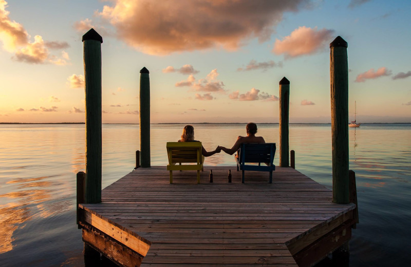 Couple holding hands on dock at Finger Lakes Premiere Properties.