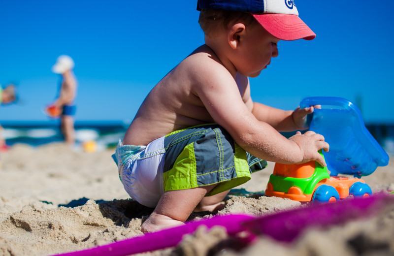 Kid playing in sand at CNE Vacation Rental.