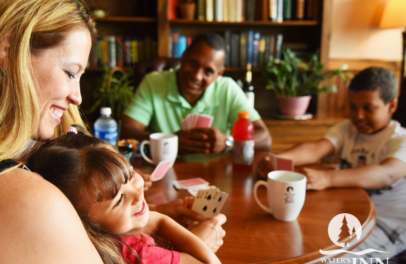 Family playing cards at Water's Edge Inn & Conference Center.