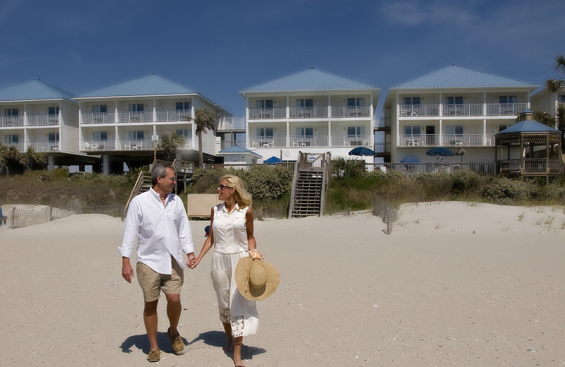 Couple on beach at Ocean Isle Inn.