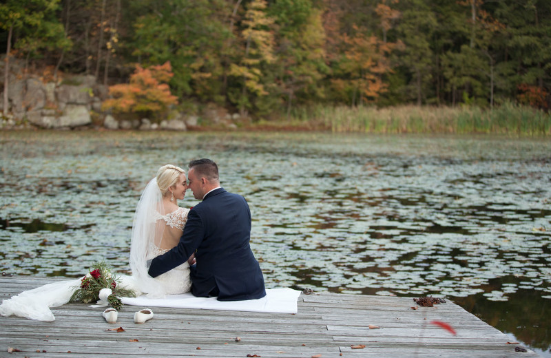 Wedding couple by lake at Arrow Park Lake and Lodge.