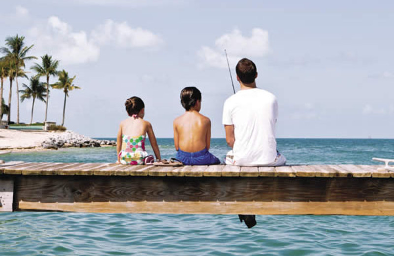 Family on dock at Sunset Key Guest Cottages, a Luxury Collection Resort.