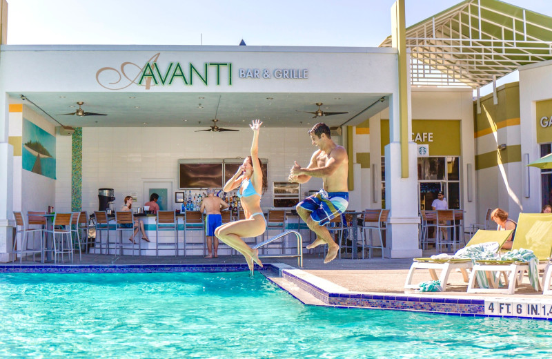 Couple jumping in pool at Avanti Resort.