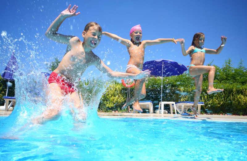 Kids jumping in pool at Lakeway Resort and Spa.