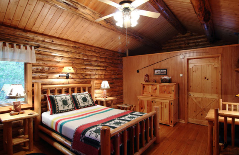 Cabin bedroom at Silverwolf Log Chalet Resort.