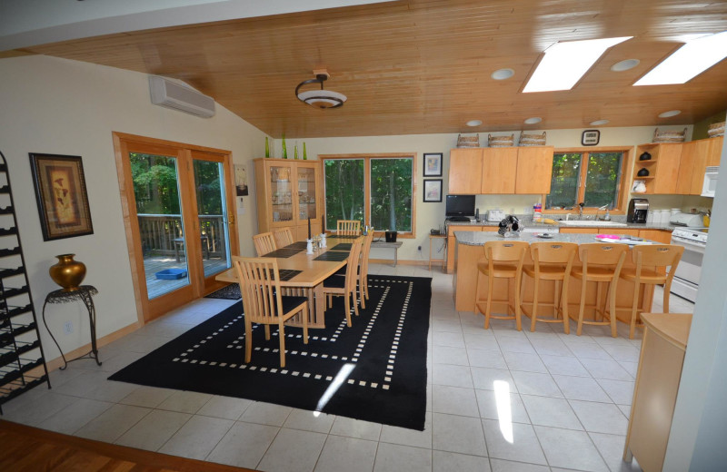 Rental kitchen and dining area at Visit Up North Vacation Rentals.