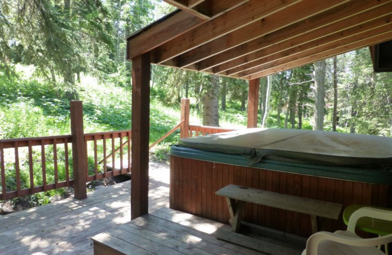Cabin deck with jacuzzi at Deadwood Connections.
