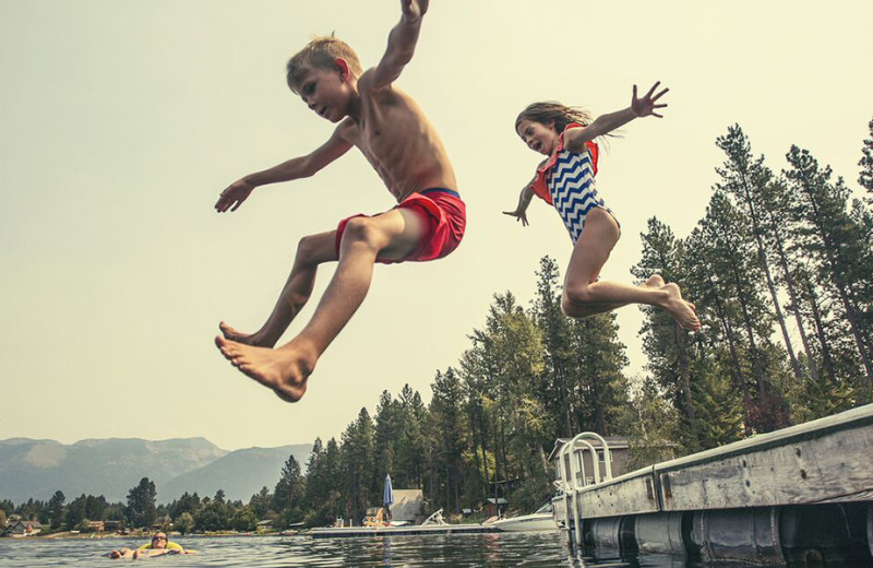 Kids jumping into lake at Westward Shores Camping Resort.