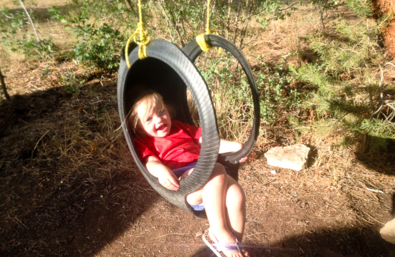 Child on tire swing at Zion Ponderosa Ranch.