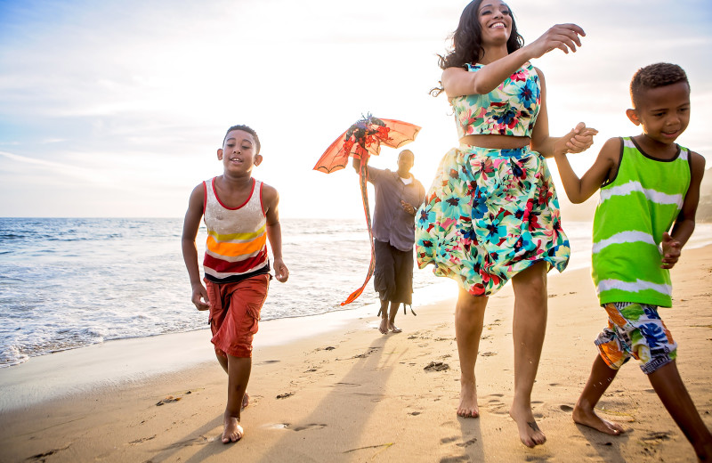 Family on beach at Walker Vacation Rentals.