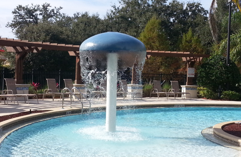 Outdoor community pool and spa at Elite Vacation Homes.