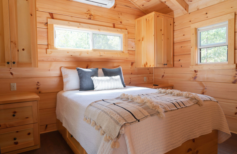 Cabin bedroom at Yogi Bear's Jellystone Park™ Camp-Resort: Golden Valley, NC.

