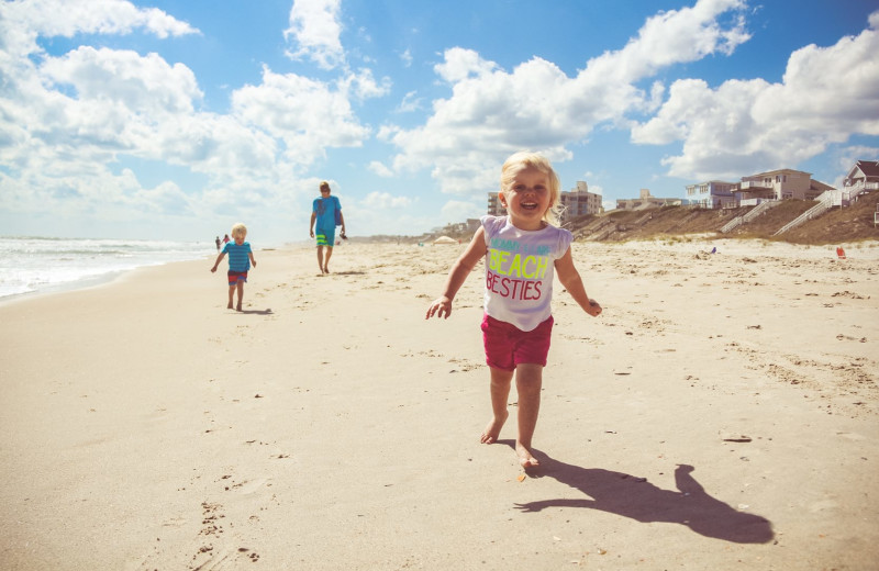 Kid running on beach at Realty World - First Coast Realty.