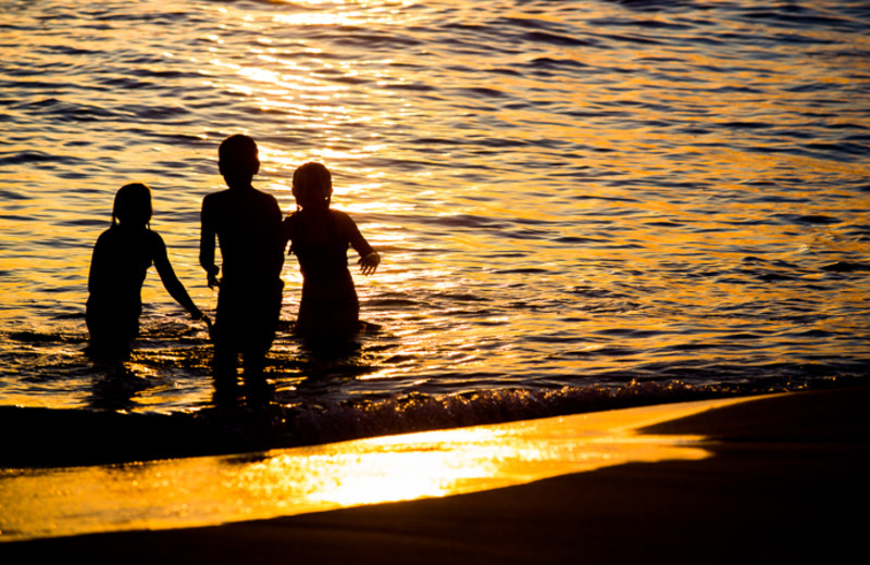 Family on beach at Seabreeze Vacation Rentals, LLC.