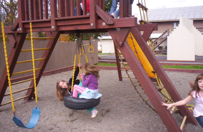 Kid on playground at Acra Manor Resort.