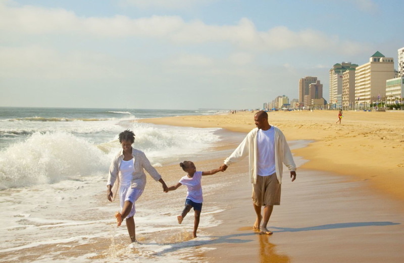 Family on beach at Dolphin Run Condominium Association. Inc.