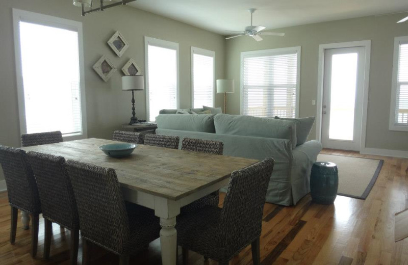 Vacation rental dining and living room at Teresa's Beach Vacation Rental Homes.