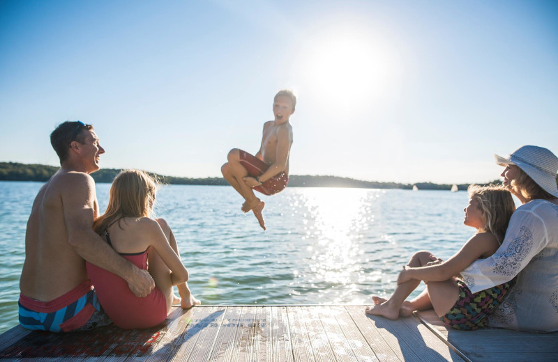Jumping in lake at The Osthoff Resort.