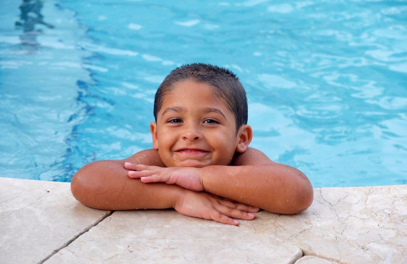 Kid in pool at Santa Maria Suites Resort.