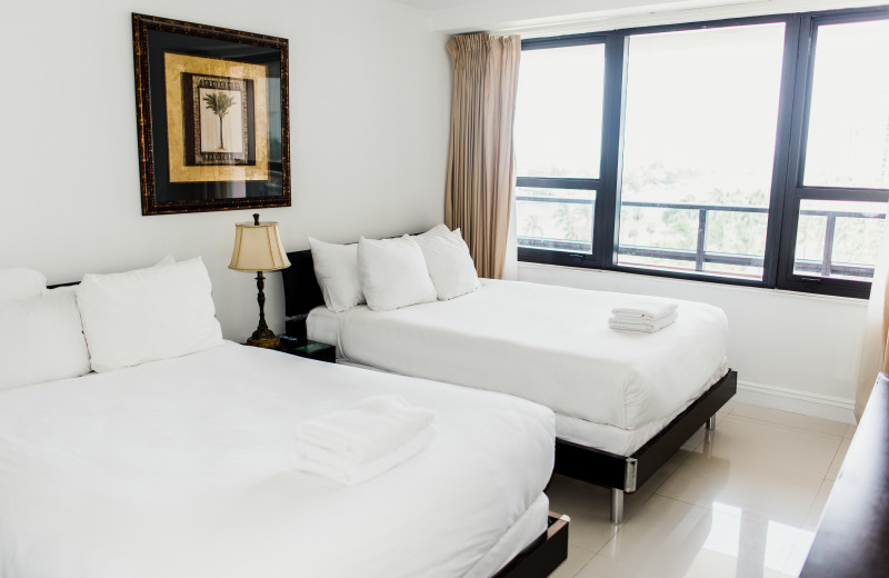 Guest bedroom at The Alexander All Suite Oceanfront Resort.