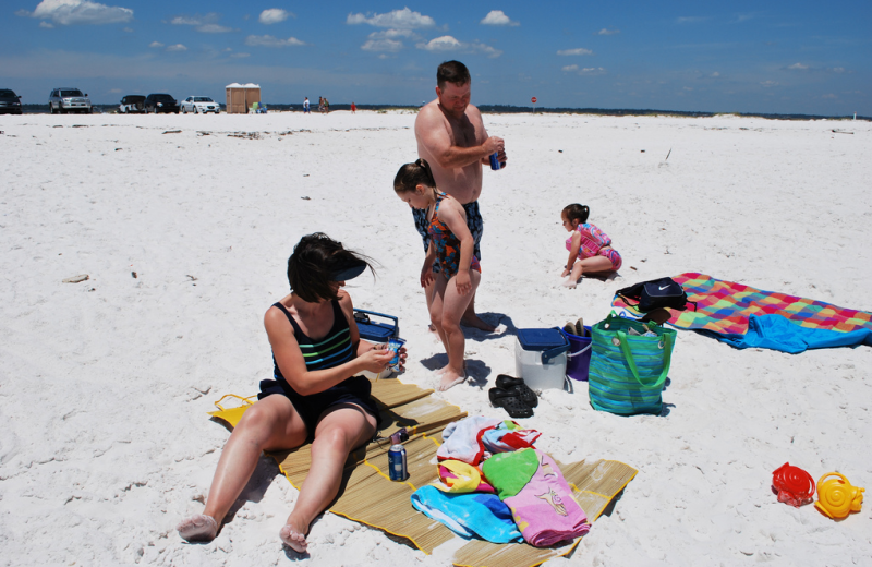 Family on the beach at Gulf Pines RV Park.