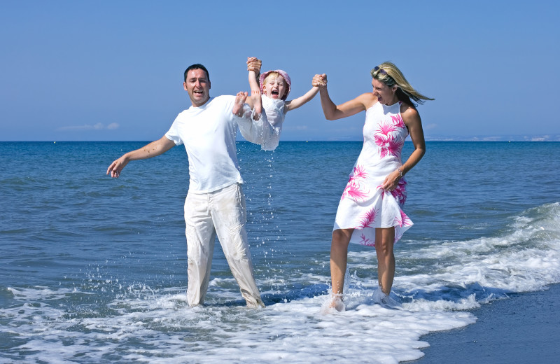 Family on beach at Surf Song Beach Resort.