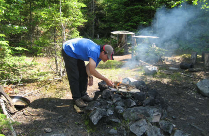 Stoking the fire at Sandy Beach Lodge.