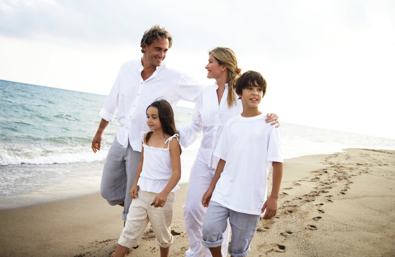 Family on beach at Grand Beach Inn.