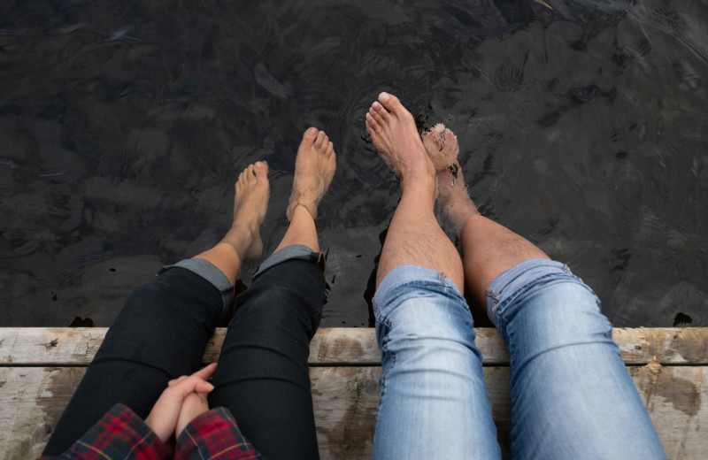 Couple siting on dock at Bartlett Lodge.