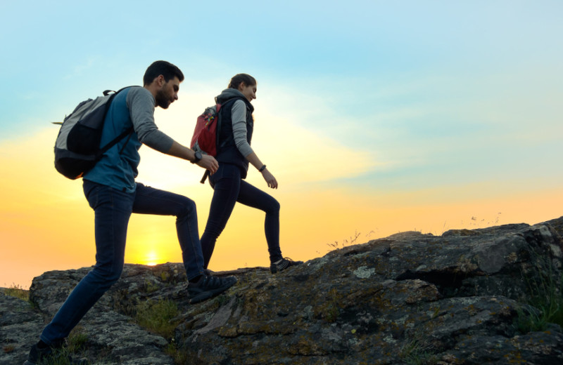 Couple hiking at The Elms Waterfront Cottages.