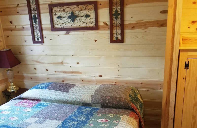 Cabin bedroom at Isle O' Dreams Lodge.