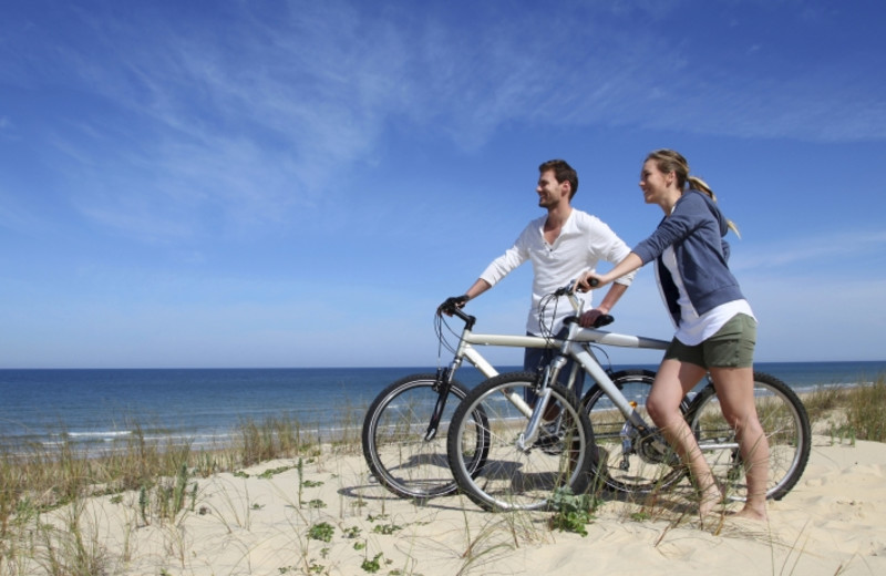 Biking on the beach at Shorepine Vacation Rentals.