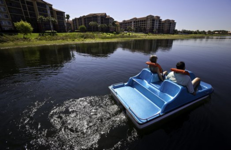 Couple on paddle boat at Westgate Lakes Resort.