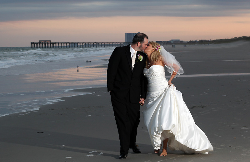 Wedding couple on beach at Springmaid Beach Resort. 