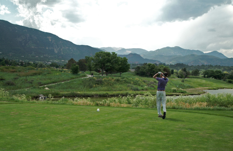 The 18-hole championship golf course at Cheyenne Mountain Resort features a rugged mountain ridge line backdrop and a private 35-acre lake.