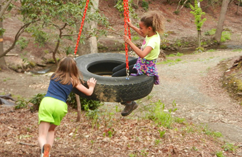 Kids on tire swing at High Rock Rentals.