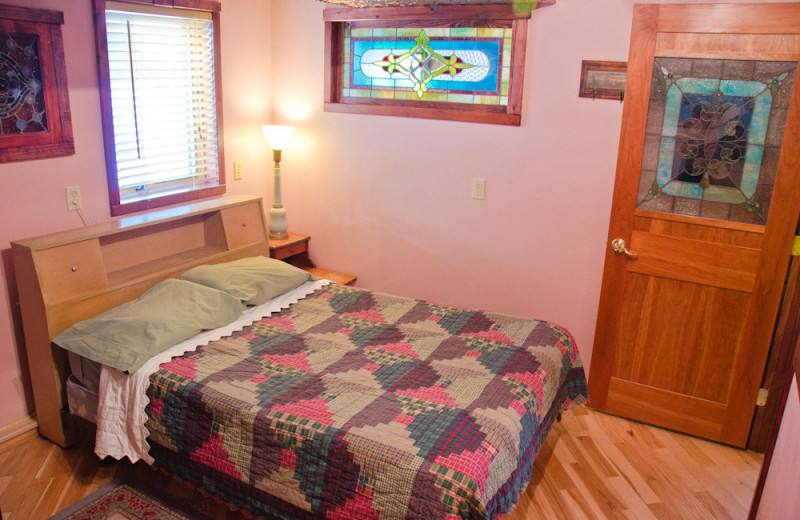 Cabin bedroom at Tri Lake Timbers Resort.