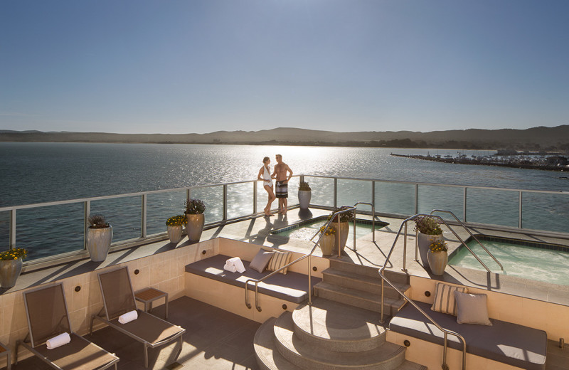 Couple enjoying the Penthouse Level sundeck and hot tubs at Vista Blue Spa.