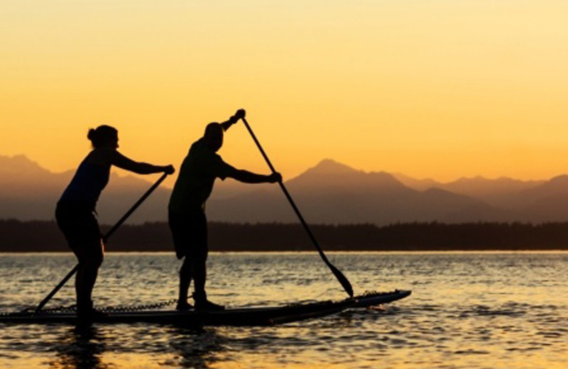 Couple paddle boarding at The Resort at Port Ludlow.